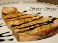 Un delicioso emperador a la plancha, con marcas de parrilla y un toque de hierbas, bañado en salsa oscura. ¡Un manjar digno de un Señor!