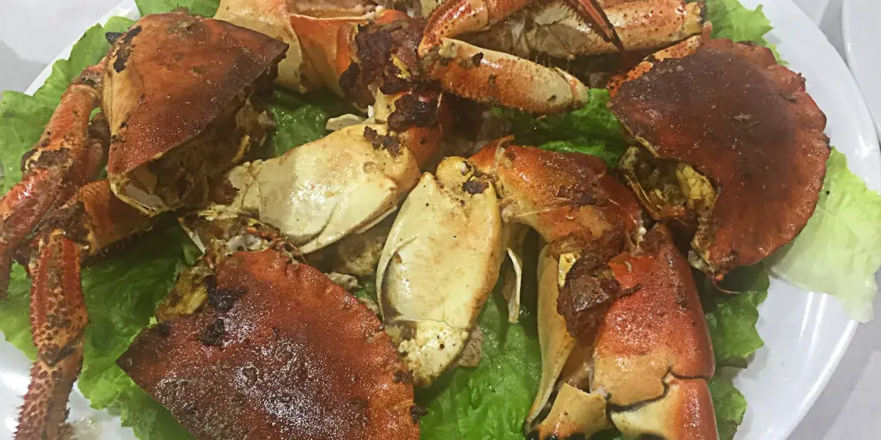 Buey de mar a la plancha servido sobre lechuga fresca. Un plato delicioso y listo para disfrutar.